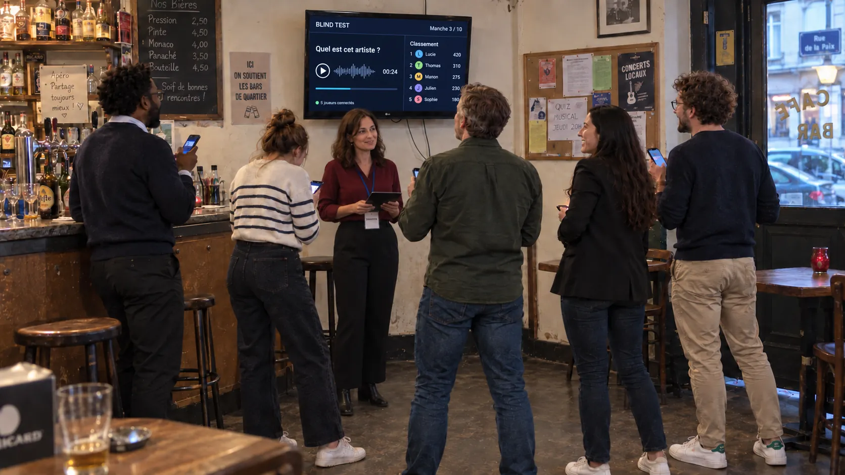 Blind test boosté à l’IA : les joueurs répondent devant la TV qui affiche la manche et le classement